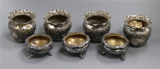 A set of four plated embossed vases and a set of three circular plated salts